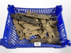 A crate of vintage brass door handle plates