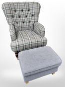 A contemporary armchair upholstered in brown leather and tartan fabric on brass castors,