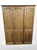 A contemporary Ducal Pine triple door wardrobe,