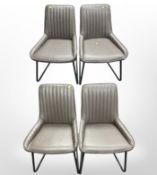 A contemporary set of four stitched vinyl dining chairs
