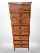 A 19th century continental oak and parquetry inlaid eight drawer tall boy with rouge marble top,