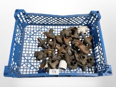 A crate of vintage metal door handle collars