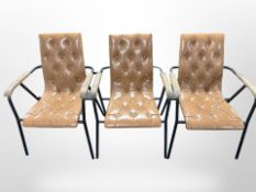 Three contemporary Scandinavian metal framed tan buttoned vinyl armchairs