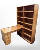 A 20th century Danish teak open bookcase incorporating a single pedestal desk,
