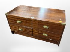 A teak effect four drawer campaign style low chest,