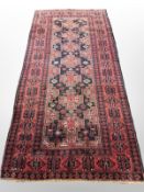A Balouch rug, Afghanistan, 243cm x 122cm.