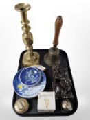 A large brass diamond-pattern candlestick, together with a vintage school bell,