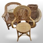 A cane and glass topped rectangular coffee table, three wicker chairs,