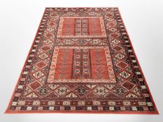 A machine made carpet of Afghan design,