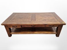 A contemporary hard wood two-tier rectangular coffee table with drawers,