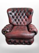 A Chesterfield oxblood buttoned leather armchair,