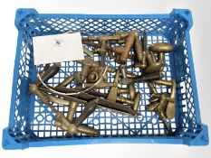 A crate of vintage brass door handles and others.