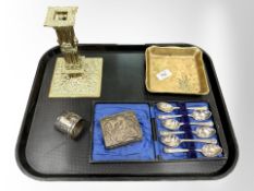 An ornate heavy cast-brass candlestick decorated with cherubs,