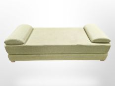 A day bed in green upholstery,