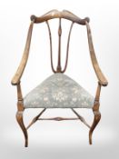 An Edwardian mahogany triangular armchair