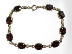 A 14ct gold garnet bracelet, length 18cm. CONDITION REPORT: 12.