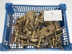 A crate of vintage brass door handles and door plates.