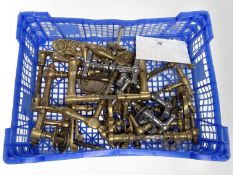 A crate of vintage brass door handles.