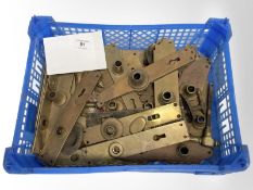 A crate of vintage brass door plates.