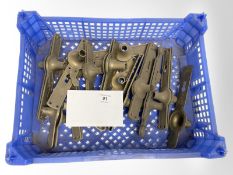 A crate of vintage brass door plates and handle collars.