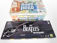 An Xbox 360 Band Hero set, and a The Beatles Rock Band guitar, both boxed.