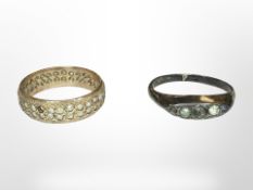A 9ct gold dress eternity ring (stones deficient) and a silver ring.