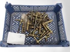 A crate of vintage brass door handles.