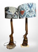 A pair of contemporary table lamps with rifle stop supports,