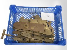 A crate of vintage brass door plates.