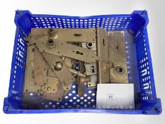 A crate of vintage brass door plates.