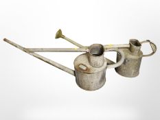 Two galvanized watering cans