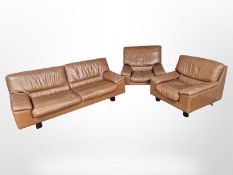 A late 20th century stitched tan leather three piece lounge suite : three seater settee,