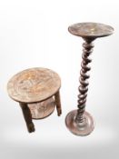 A barley twist torchere and an Eastern heavily carved tripod table