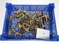 A crate of vintage brass door handles.