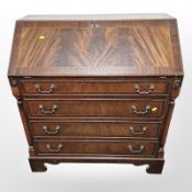 A reproduction inlaid mahogany bureau,