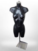 A female mannequin on chrome stand