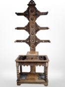 A Victorian heavily carved oak hall stand, with lead lined drip trays beneath and central drawer,