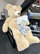 A large teddy bear and two further soft toys