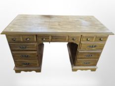 A reproduction seven drawer twin pedestal desk,