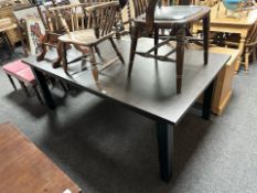 A contemporary stained pine extending dining table,