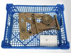 A crate of vintage brass door plates and two handles.