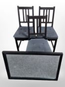 A contemporary ebonised mirror and three dining chairs