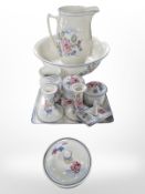 An English pottery transfer-printed wash jug and basin and several matching dressing table pieces.