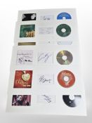 A group of CDs mounted to card, with facsimile artists' signatures.