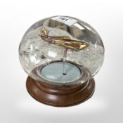 A Northumbrian glass spitfire under glass dome.