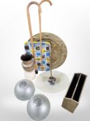 A large embossed brass charger, pair of etched glass shades, walking sticks, brass magazine rack,