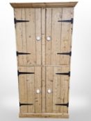 A late Victorian pine four door pantry cupboard, with painted shelved interior,