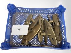 A crate of vintage brass door plates.