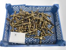 A crate of vintage brass door handles.