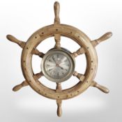 A quartz wall timepiece in the form of a ship's wheel, diameter 62cm.